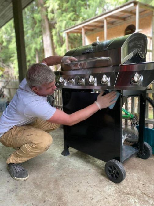Richard cleaning a BBQ exterior